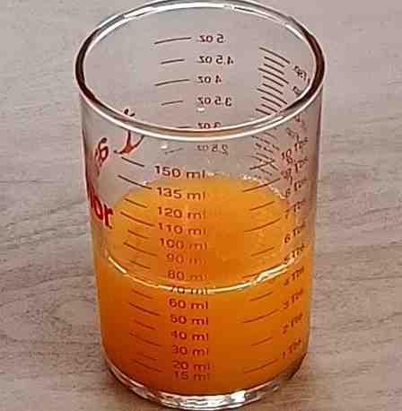60 mL orange juice in a measuring cup